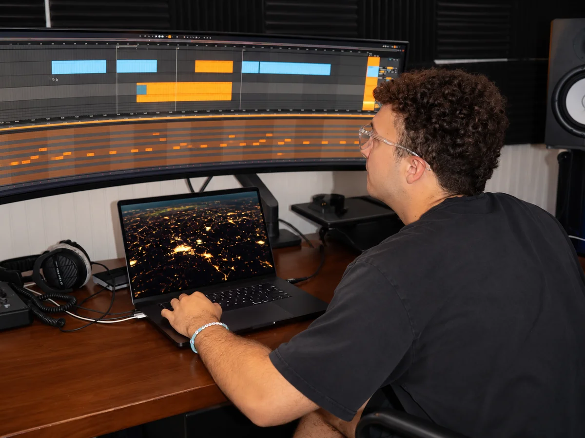 Alex making music at his studio desk